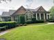 Beautiful brick home with columns, meticulously landscaped yard, and inviting walkway at 7970 Berea Rd, Winston, GA 30187