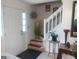 Foyer with a white front door, carpeted stairs, and decorative accents at 3232 Deer Pause Ln, Decatur, GA 30034