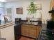 Efficient kitchen featuring black countertops, wood cabinets, and essential appliances for cooking at 3232 Deer Pause Ln, Decatur, GA 30034