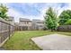 Wide backyard featuring a concrete patio, a fenced in yard, and green grass at 529 Dasheill Ln, Atlanta, GA 30349