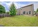 A grassy backyard with a patio and a wooden fence at 529 Dasheill Ln, Atlanta, GA 30349