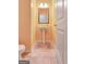 Cozy half-bathroom featuring stylish pedestal sink, decorative mirror and light fixture at 529 Dasheill Ln, Atlanta, GA 30349