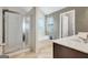 Well-lit bathroom with glass shower, soaking tub, double sinks, and tile flooring at 529 Dasheill Ln, Atlanta, GA 30349