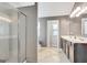 Large bathroom with a glass shower, double vanity, tiled floor, and neutral paint at 529 Dasheill Ln, Atlanta, GA 30349
