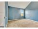 Empty bedroom featuring blue walls and tan carpet at 529 Dasheill Ln, Atlanta, GA 30349