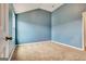 Spacious empty bedroom featuring light blue walls and tan carpet at 529 Dasheill Ln, Atlanta, GA 30349