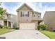 Charming two-story home featuring stone accents, a two-car garage, and manicured landscaping at 529 Dasheill Ln, Atlanta, GA 30349