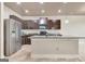 Modern kitchen featuring stainless steel appliances, granite countertops, island with tile floors, and recessed lighting at 529 Dasheill Ln, Atlanta, GA 30349