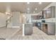 Well-equipped kitchen with stainless steel appliances and dark wood cabinets, adjacent to the living area and stairs at 529 Dasheill Ln, Atlanta, GA 30349