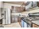 Well-lit kitchen featuring stainless steel appliances, granite countertops, and tile flooring at 529 Dasheill Ln, Atlanta, GA 30349