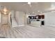 Open floor plan with stairs, kitchen and dining areas featuring gray wood flooring and recessed lighting at 529 Dasheill Ln, Atlanta, GA 30349