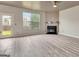 Spacious living room with a fireplace, ceiling fan, large window and access to the outside at 529 Dasheill Ln, Atlanta, GA 30349
