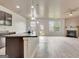 An open floor plan with a kitchen island overlooking the living room and fireplace area at 529 Dasheill Ln, Atlanta, GA 30349