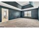Bright main bedroom featuring plush carpeting, a window, and an open doorway to the bathroom at 529 Dasheill Ln, Atlanta, GA 30349