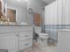 Cozy bathroom with a white vanity, toilet, and shower-tub combo featuring a blue patterned shower curtain at 2866 Rosecommons Dr, Hampton, GA 30228