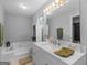 Bright bathroom features a large soaking tub and a double sink vanity offering convenience and style at 2866 Rosecommons Dr, Hampton, GA 30228