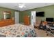 Comfortable bedroom with carpet flooring, ceiling fan, and an ensuite bathroom at 2866 Rosecommons Dr, Hampton, GA 30228