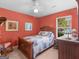 Comfortable bedroom with a wooden bed, artwork, and a window, creating a relaxing retreat at 2866 Rosecommons Dr, Hampton, GA 30228