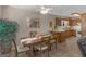 Cozy dining area showcasing a wooden table, chairs, and a view of the adjacent kitchen for easy serving at 2866 Rosecommons Dr, Hampton, GA 30228