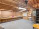 Spacious garage interior featuring a workbench, pegboard, and ample storage shelving at 2866 Rosecommons Dr, Hampton, GA 30228