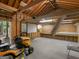 Well-lit garage interior featuring a workbench, pegboard wall, and overhead ladder storage at 2866 Rosecommons Dr, Hampton, GA 30228