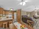 Inviting kitchen and open dining area, perfect for Gathering meals and entertaining with connecting living room at 2866 Rosecommons Dr, Hampton, GA 30228