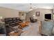 Expansive living room featuring a vaulted ceiling, stone fireplace, and plush leather seating arrangement at 2866 Rosecommons Dr, Hampton, GA 30228