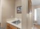 Practical wet bar featuring wood cabinets, sink, and picture rail detail conveniently situated next to the foyer at 2866 Rosecommons Dr, Hampton, GA 30228