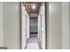 Hallway lined with white sliding doors and a view into the open ceiling basement at 11 Chad Ct, Mcdonough, GA 30253