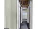 Hallway lined with white sliding doors and a view into the unfinished basement at 11 Chad Ct, Mcdonough, GA 30253