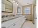 Bathroom featuring double sinks, granite counters, and white cabinets at 11 Chad Ct, Mcdonough, GA 30253