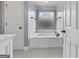 Bright bathroom showcases a soaking tub with decorative window for added privacy at 11 Chad Ct, Mcdonough, GA 30253
