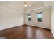 The light filled bedroom features hardwood floors, tray ceiling, ceiling fan, and two windows at 11 Chad Ct, Mcdonough, GA 30253