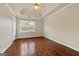 Spacious bedroom features beautiful hardwood floors, modern fan, and recessed tray ceiling at 11 Chad Ct, Mcdonough, GA 30253