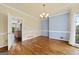 Dining room with hardwood floors, chandelier and light blue accent wall, as well as large bright window at 11 Chad Ct, Mcdonough, GA 30253