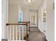 Upstairs hallway with carpet and multiple doorways leading to different rooms in the house at 11 Chad Ct, Mcdonough, GA 30253