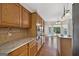 Kitchen with wooden cabinets, granite countertops, and a view into the backyard pool at 11 Chad Ct, Mcdonough, GA 30253