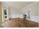 Spacious living room with hardwood floors, large window, and glass doors to another room at 11 Chad Ct, Mcdonough, GA 30253
