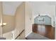 Upstairs landing area overlooking large bonus room with hardwood floors and natural light at 11 Chad Ct, Mcdonough, GA 30253