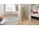 Bathroom with a soaking tub, separate shower, and tiled walls at 845 Graeme Dr, Mcdonough, GA 30252