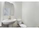 Bathroom with a pedestal sink and elongated toilet at 845 Graeme Dr, Mcdonough, GA 30252