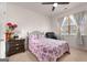 Cozy bedroom showcasing a comfortable bed, a black accent chair, and a bright window at 845 Graeme Dr, Mcdonough, GA 30252