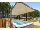 Relaxing covered hot tub area with beautiful views of the backyard and surrounding wooded area at 845 Graeme Dr, Mcdonough, GA 30252