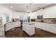 Bright kitchen featuring white cabinetry, granite counters and an island at 845 Graeme Dr, Mcdonough, GA 30252