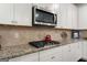 A kitchen showcasing granite countertops, stainless steel appliances, and white cabinets at 845 Graeme Dr, Mcdonough, GA 30252