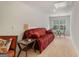 Inviting living room featuring a red sofa, chair, side table and window seating area at 845 Graeme Dr, Mcdonough, GA 30252