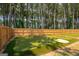 Backyard putting green with sand trap and multiple holes, perfect for honing your short game at 845 Graeme Dr, Mcdonough, GA 30252