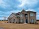 Beautiful two-story brick home with a manicured lawn and inviting entryway at 5565 Hwy 155 N, Stockbridge, GA 30281