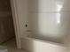 Unfinished bathroom showcasing a white tub and shower stall at 5565 Hwy 155, Stockbridge, GA 30281