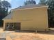 Exterior side view of a house showing siding, an attached garage and new construction at 5565 Hwy 155, Stockbridge, GA 30281